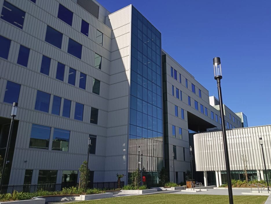 Multi-storey hospital building with grass area and lamp pole